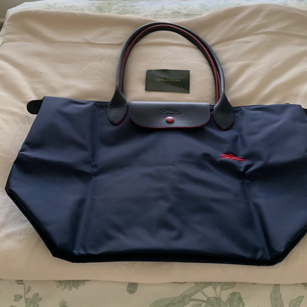Longchamp tote. Brand new without tags. Leather and nylon, navy with red trim.